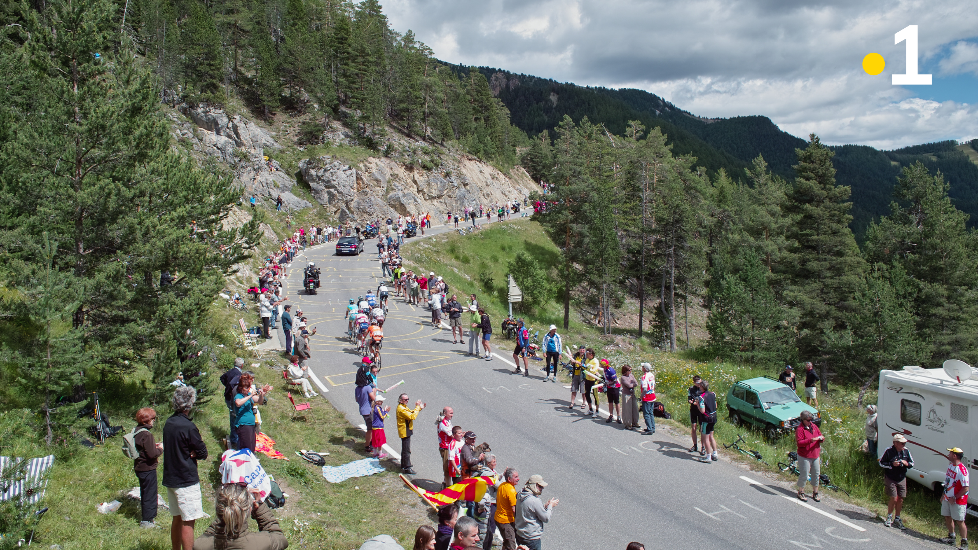 grand angle de cyclistes et de supporters sur une route de montagne