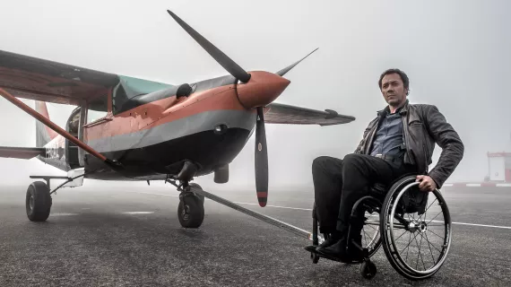 Caïn S4 portrait de  Bruno Debrandt (Caïn), à côté d'un avion à hélice
